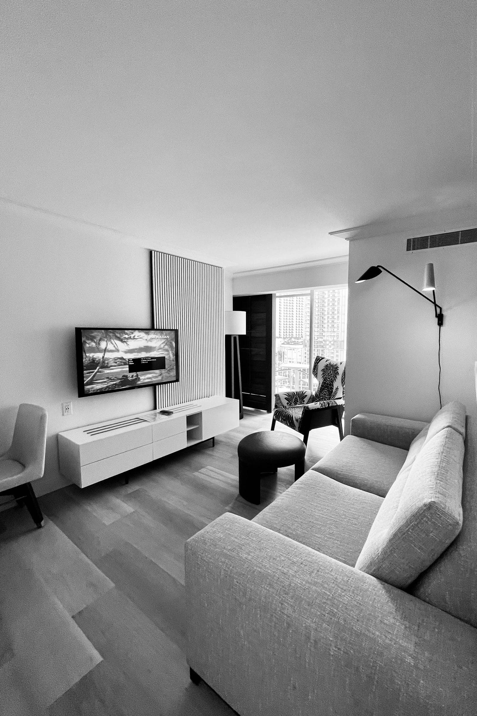 Elegant black and white minimalist lounge with a wall-mounted TV